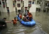 Flood-affected villages in Punjab submerged under water during 2025 monsoon floods – rescue teams helping displaced families.