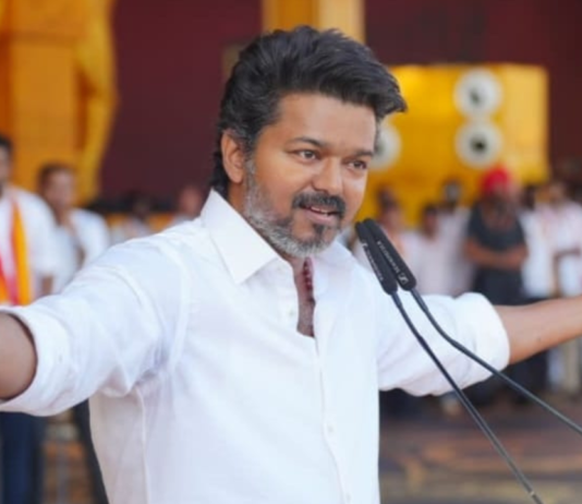 Actor Vijay (Thalapathy) supporters celebrating TVK party's lead in Tamil Nadu Assembly Elections 2026 with posters and sweets in Chennai.